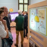 Two adults look at an interactive exhibit about food