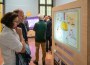 Two adults look at an interactive exhibit about food